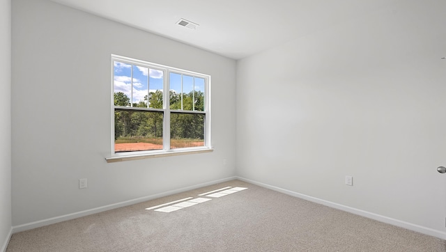 carpeted spare room with baseboards
