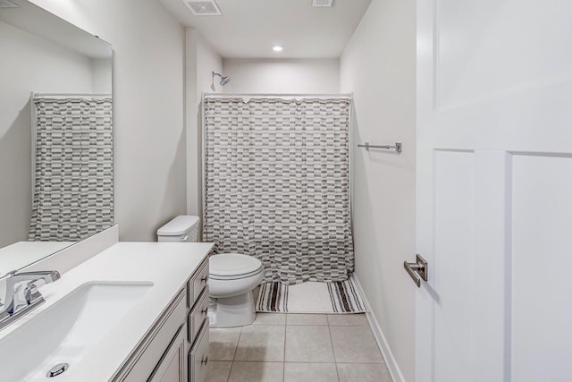 bathroom featuring visible vents, toilet, vanity, tile patterned flooring, and walk in shower