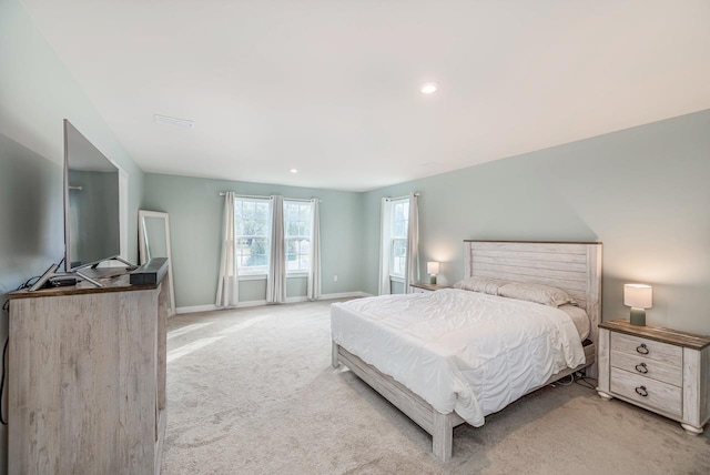 bedroom featuring light carpet, baseboards, and recessed lighting