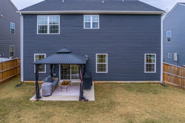 rear view of house with a fenced backyard, a yard, a gazebo, and a patio