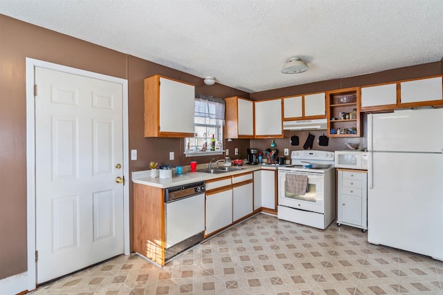 kitchen featuring white appliances, light countertops, a sink, and white cabinetry