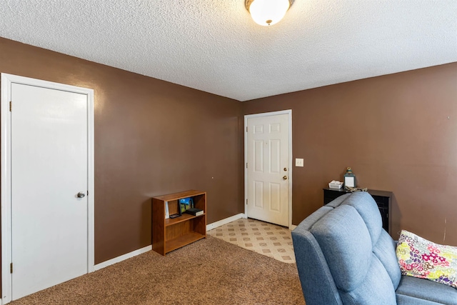 home office featuring light carpet, a textured ceiling, and baseboards