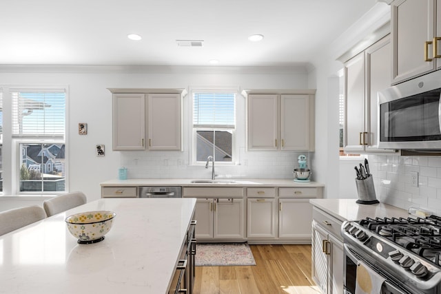 kitchen with a healthy amount of sunlight, visible vents, appliances with stainless steel finishes, and a sink