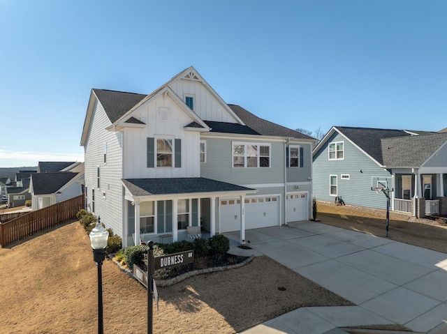 view of front facade featuring a garage, concrete driveway, roof with shingles, fence, and board and batten siding