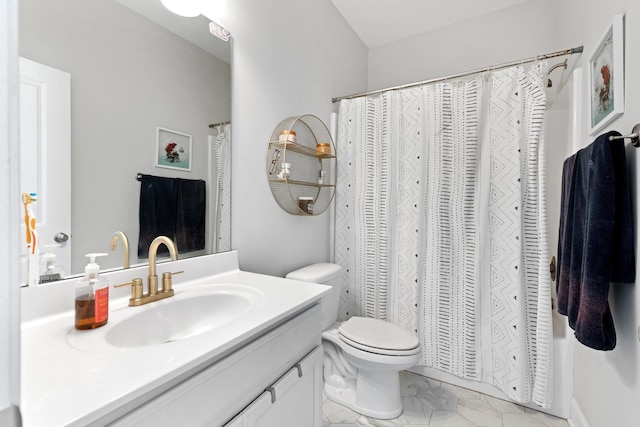 bathroom with marble finish floor, vanity, and toilet