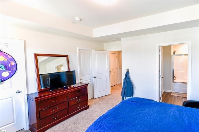 carpeted bedroom with connected bathroom