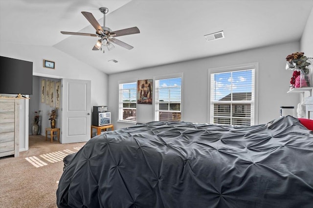 bedroom with vaulted ceiling, ceiling fan, visible vents, and light colored carpet