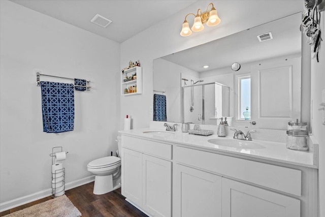 bathroom with a stall shower, visible vents, a sink, and toilet