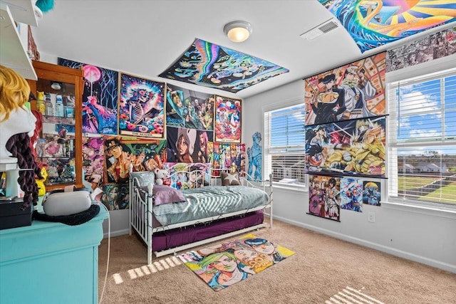 carpeted bedroom featuring baseboards and visible vents