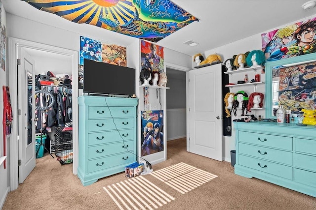 carpeted bedroom featuring a closet, visible vents, and a spacious closet