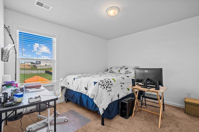 carpeted bedroom with visible vents and baseboards