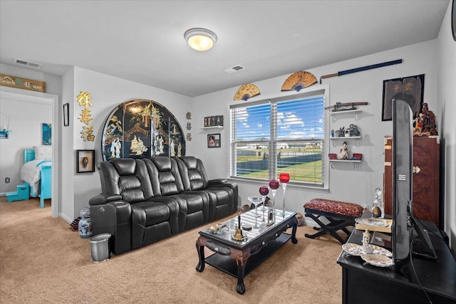 living room featuring carpet, visible vents, and baseboards