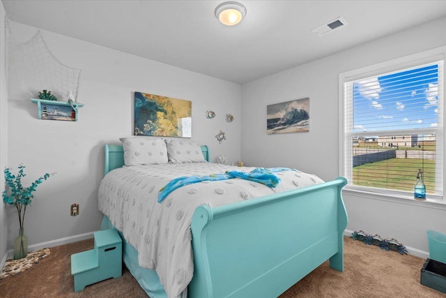 carpeted bedroom with visible vents and baseboards