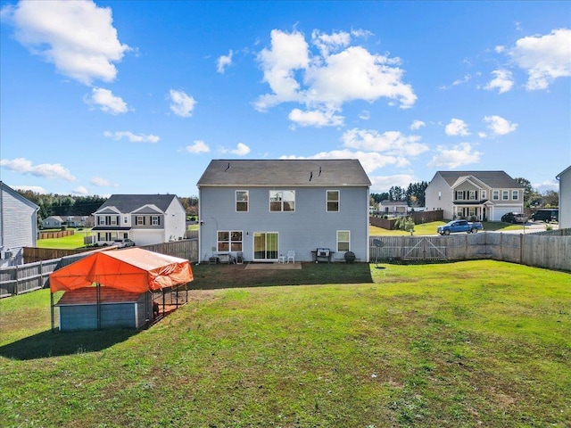 back of property with a yard, a fenced backyard, and a residential view