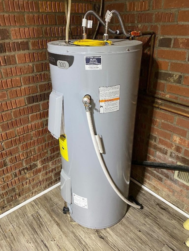 utility room featuring electric water heater