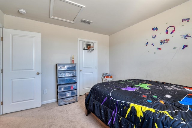 bedroom with carpet floors, attic access, and visible vents