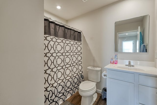 full bathroom with a shower with shower curtain, vanity, and toilet