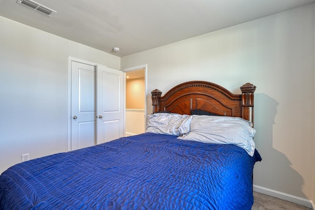 carpeted bedroom featuring visible vents and baseboards