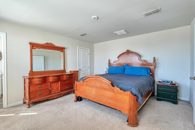 carpeted bedroom featuring baseboards and visible vents