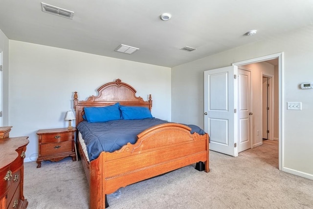 bedroom featuring light colored carpet, visible vents, and baseboards