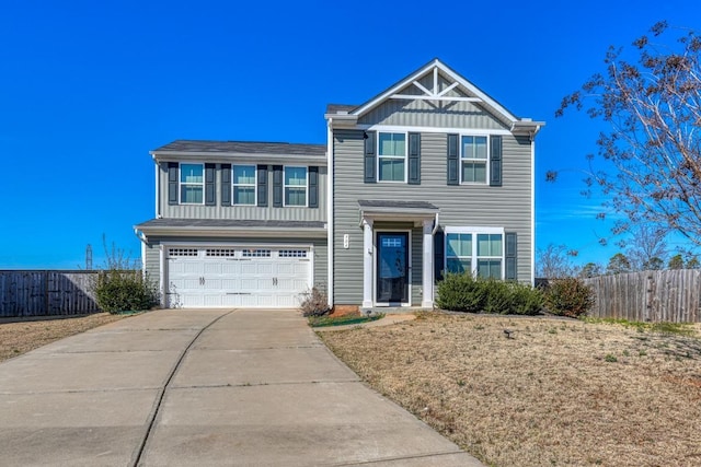 view of front of property with an attached garage, board and batten siding, fence, and concrete driveway