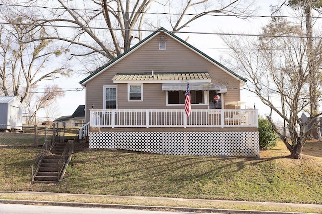 view of front of house with a front yard and fence