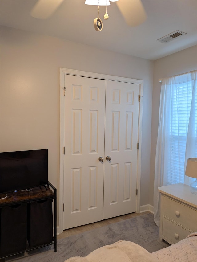 bedroom featuring a closet, visible vents, and baseboards