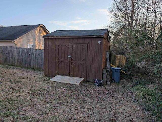 view of shed featuring fence