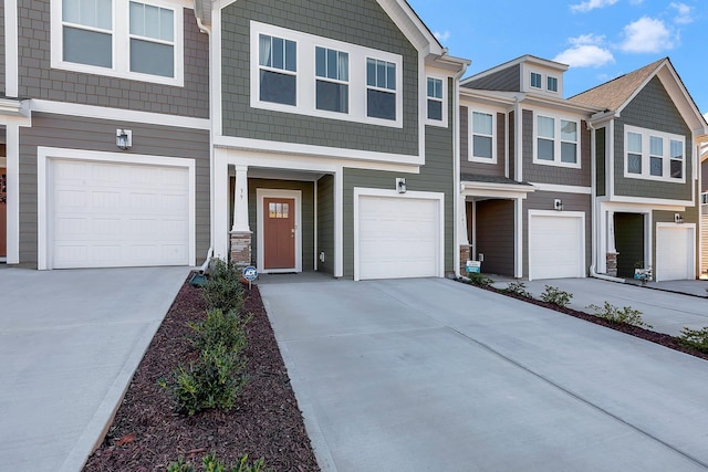 view of property with a garage and driveway