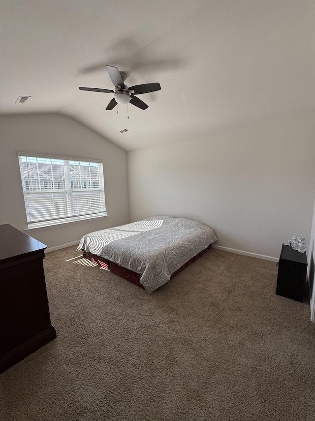 bedroom featuring carpet, lofted ceiling, visible vents, ceiling fan, and baseboards