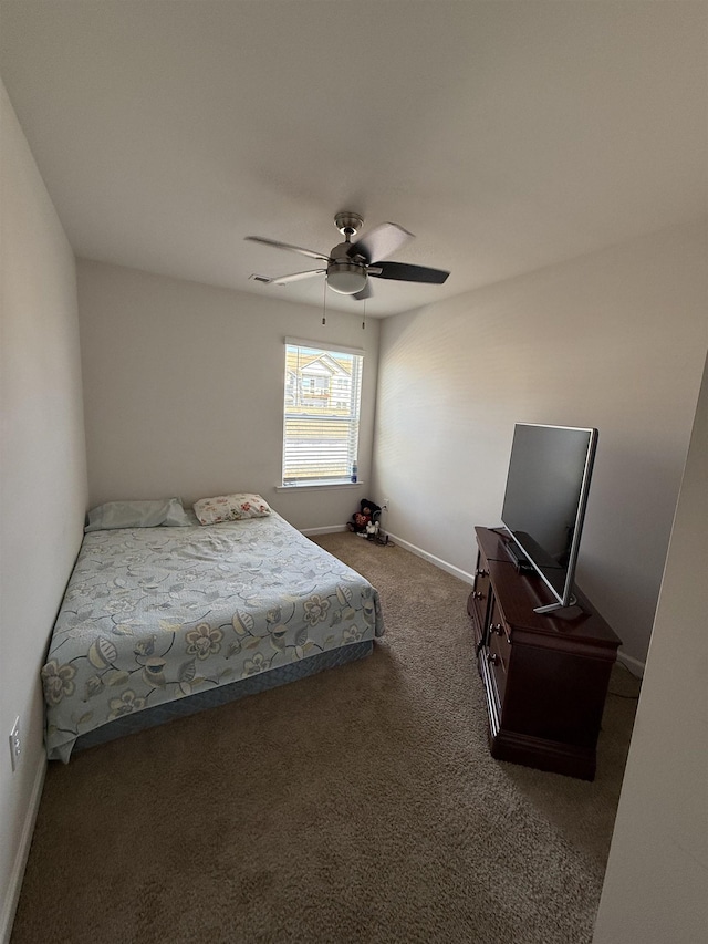 carpeted bedroom with baseboards and a ceiling fan