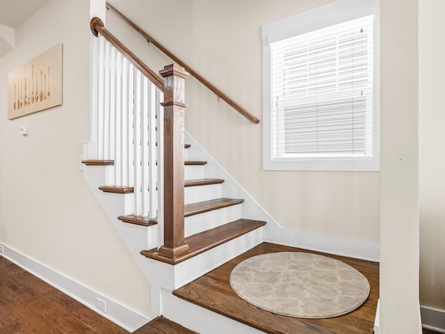 stairway featuring baseboards and wood finished floors