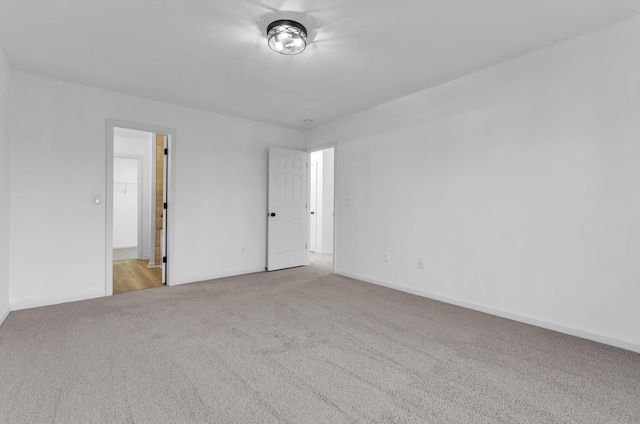 unfurnished bedroom featuring carpet floors and baseboards