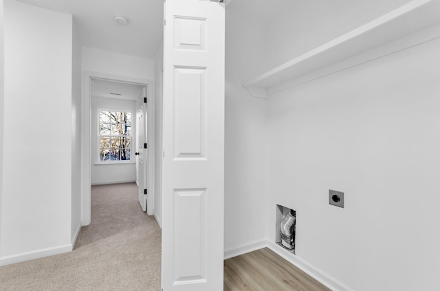 laundry area featuring light colored carpet, laundry area, hookup for an electric dryer, and baseboards