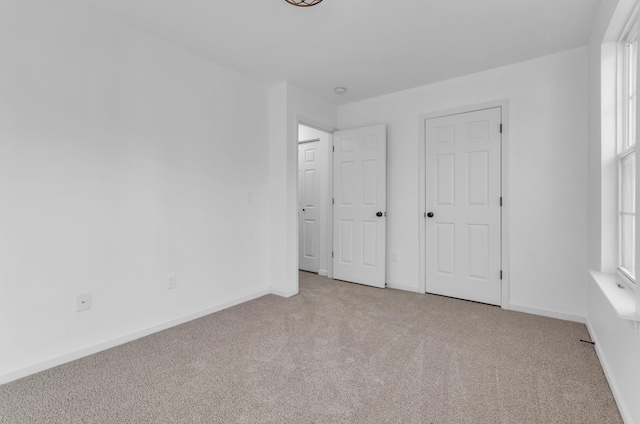 unfurnished bedroom with carpet and baseboards