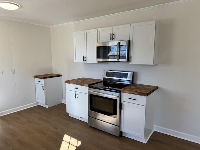 kitchen with dark wood-style floors, appliances with stainless steel finishes, wooden counters, and crown molding