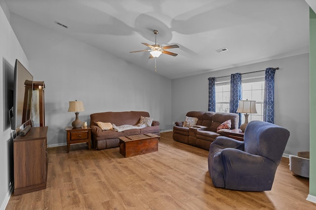 living area featuring vaulted ceiling, ceiling fan, light wood-style flooring, and visible vents