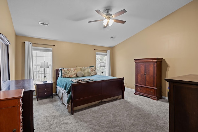 bedroom with lofted ceiling, light carpet, visible vents, and a ceiling fan