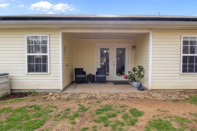 view of exterior entry featuring a patio, french doors, and roof mounted solar panels