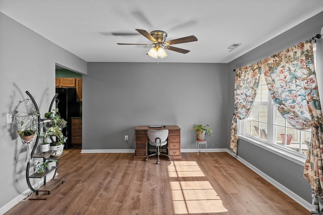 office area featuring light wood-type flooring, baseboards, and visible vents