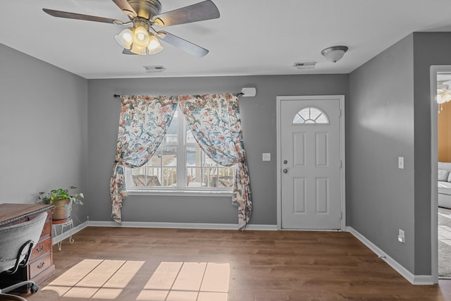 foyer entrance with a healthy amount of sunlight, visible vents, and wood finished floors