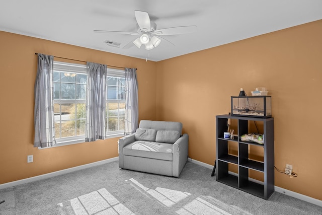 living area with a ceiling fan, carpet flooring, visible vents, and baseboards