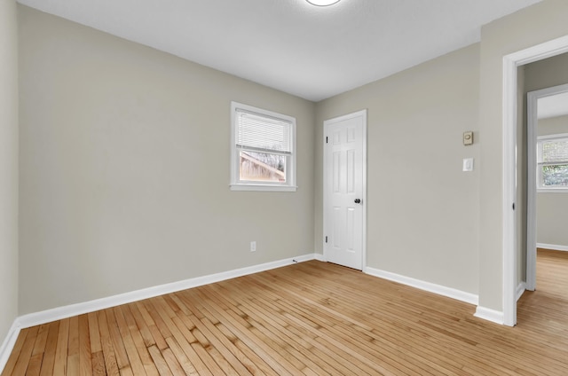 interior space featuring baseboards and light wood-style floors