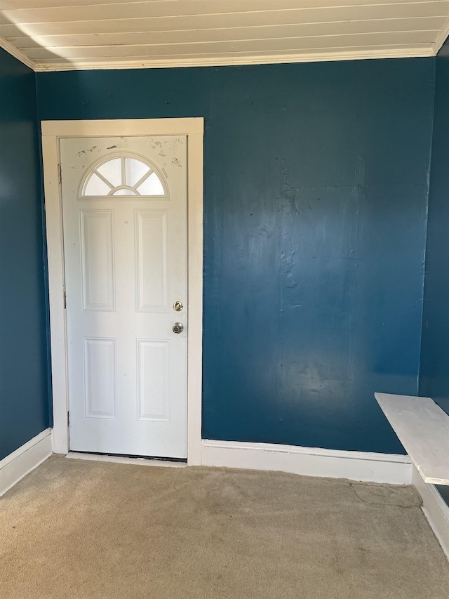 foyer featuring carpet floors and ornamental molding