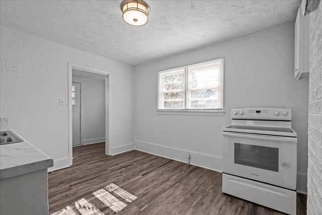 kitchen with light countertops, a textured ceiling, dark wood-style floors, white electric range, and baseboards