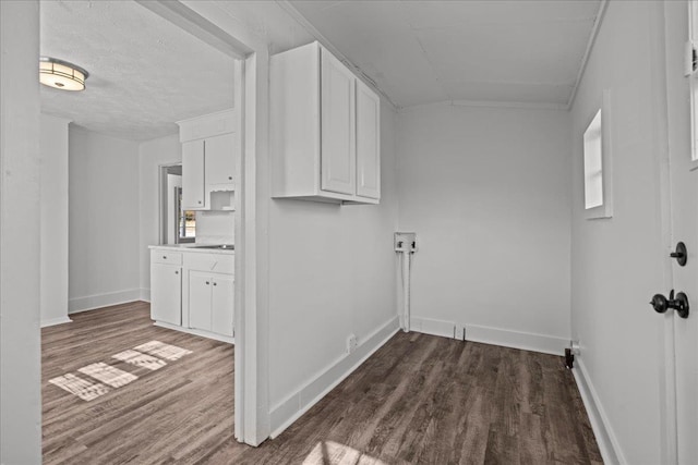 clothes washing area with baseboards, laundry area, and dark wood-style flooring