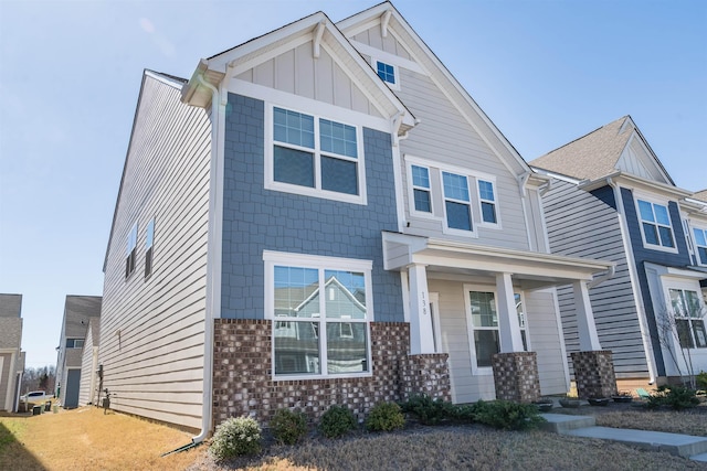 craftsman-style home featuring board and batten siding and brick siding