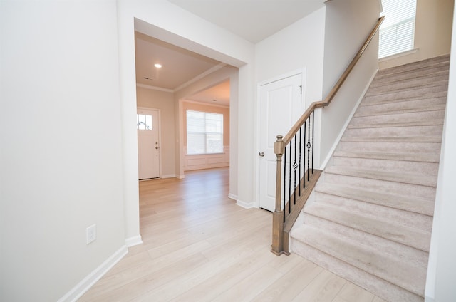 stairway with recessed lighting, baseboards, wood finished floors, and ornamental molding