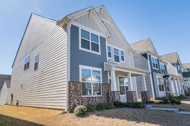 view of front of house featuring board and batten siding and brick siding