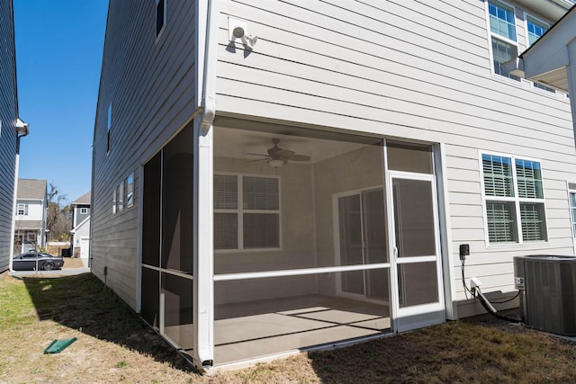 back of house featuring central AC and a sunroom